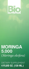 Person adding moringa liquid to a glass for daily health routine