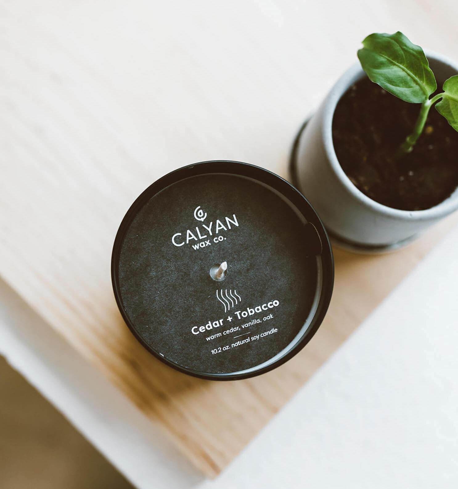 Matte black tumbler candle on a surface