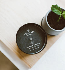 Matte black tumbler candle on a surface