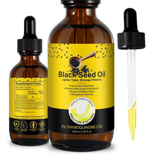 Bottle of organic black seed oil on white background