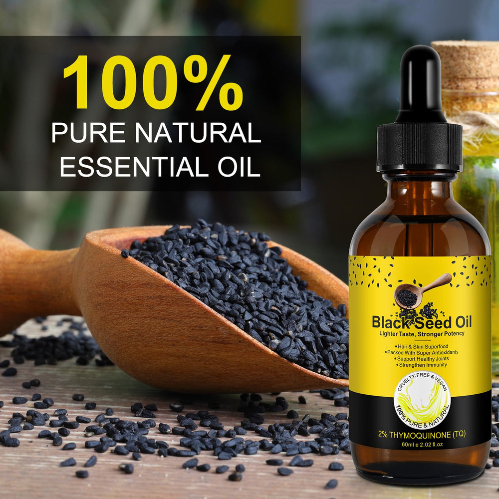Pouring black seed oil from a dropper