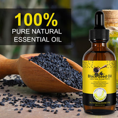 Pouring black seed oil from a dropper