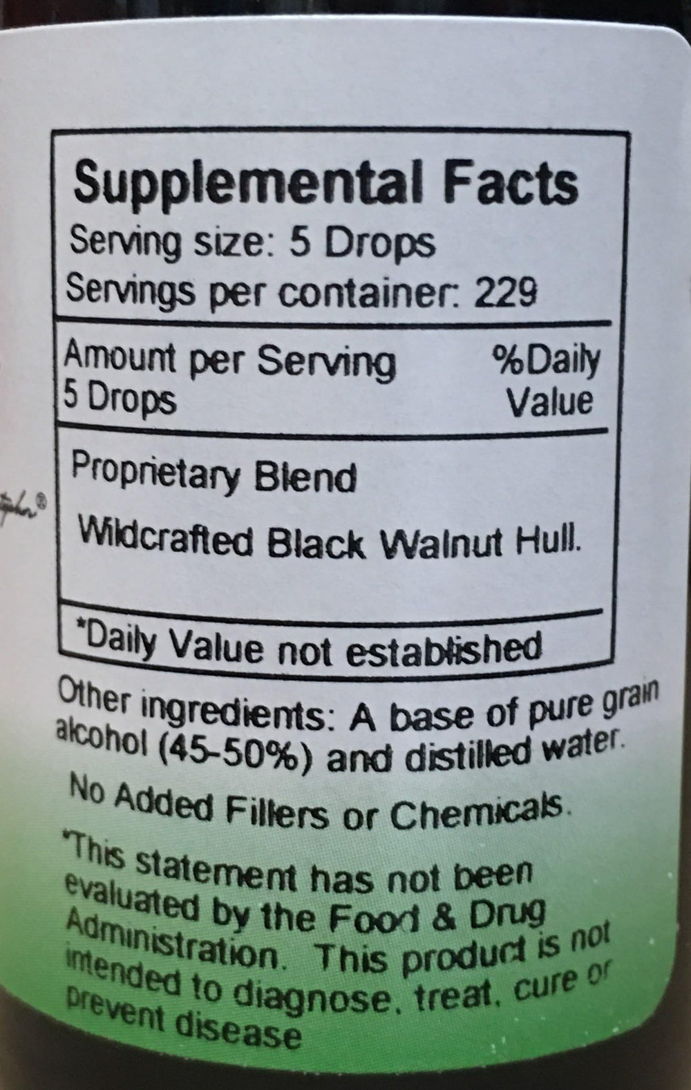 Liquid black walnut extract being dispensed with a dropper