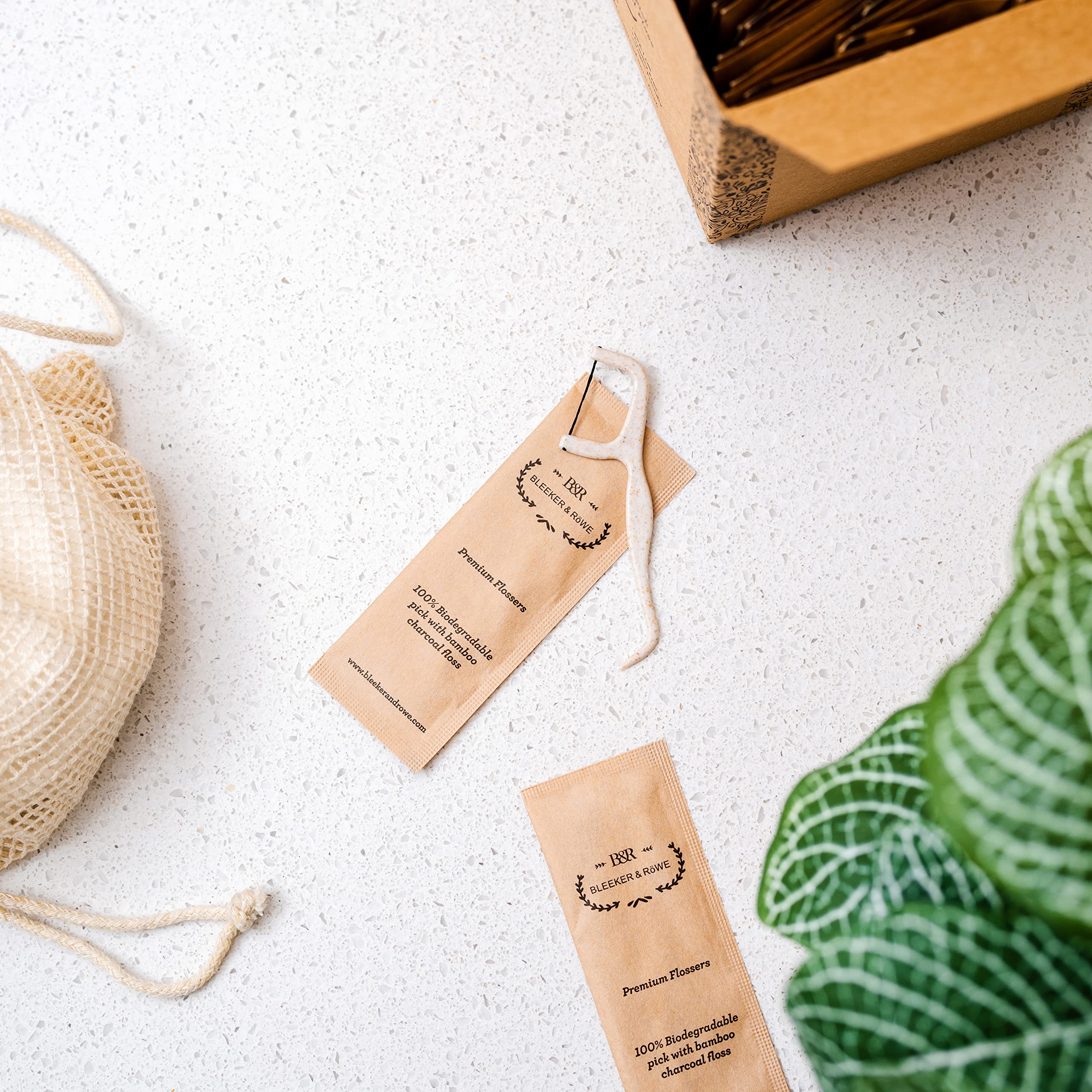 Individually wrapped floss picks in recyclable paper sleeves