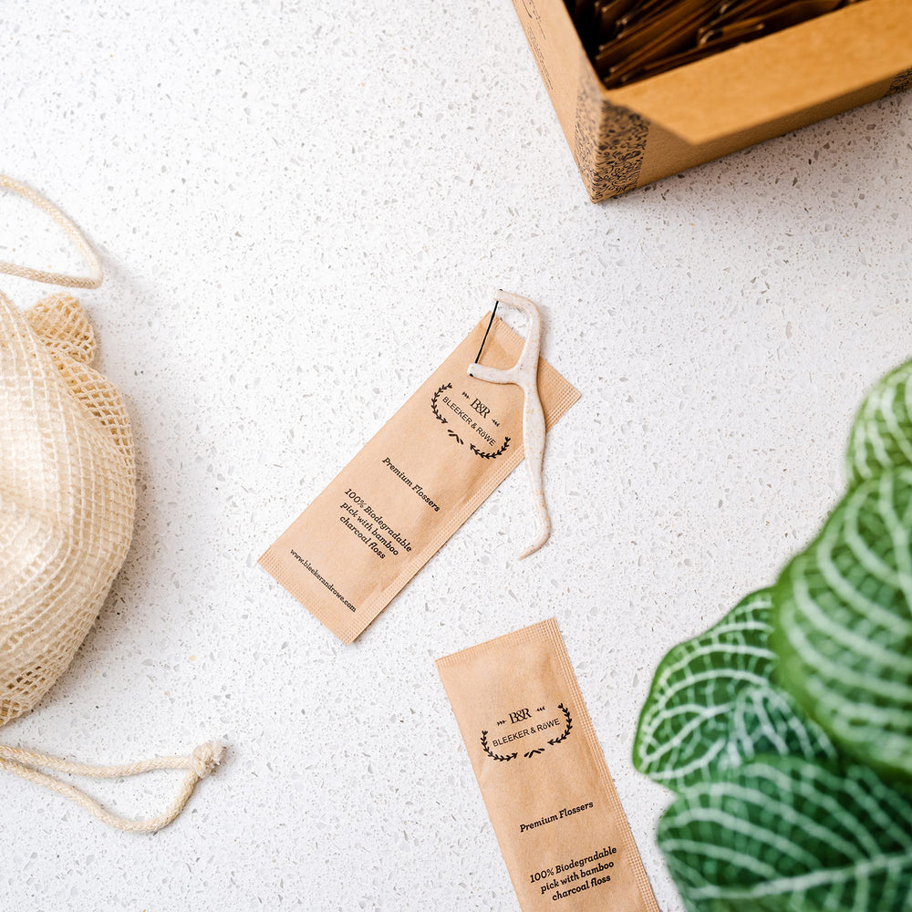 Individually wrapped floss picks in recyclable paper sleeves