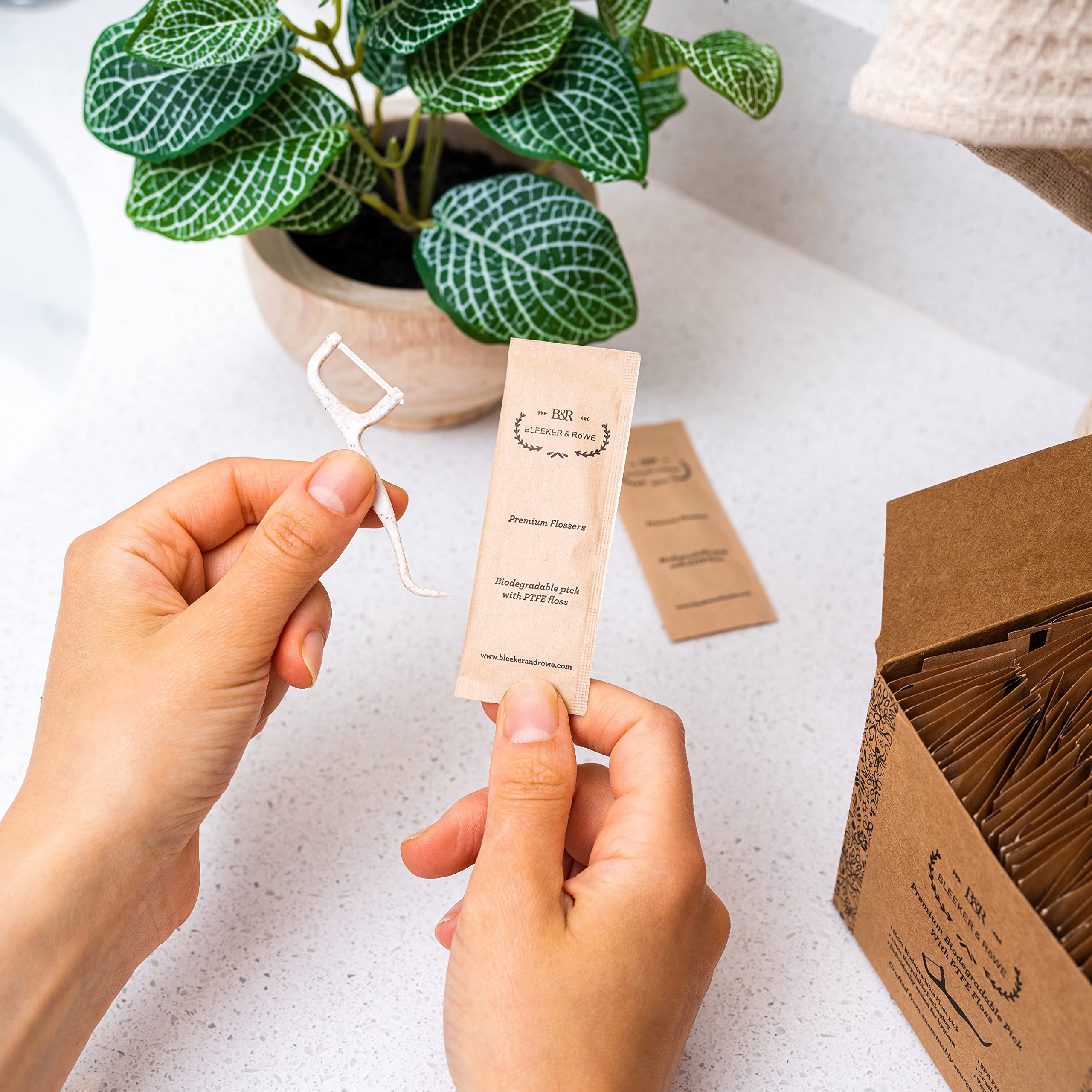 Individually wrapped floss picks in recyclable paper sleeve