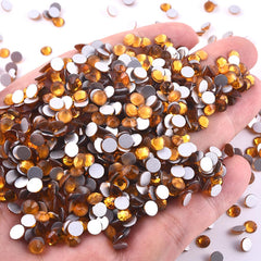 BLINGINBOX nail art decorations showcase topaz sparkle on clothes or accessories.