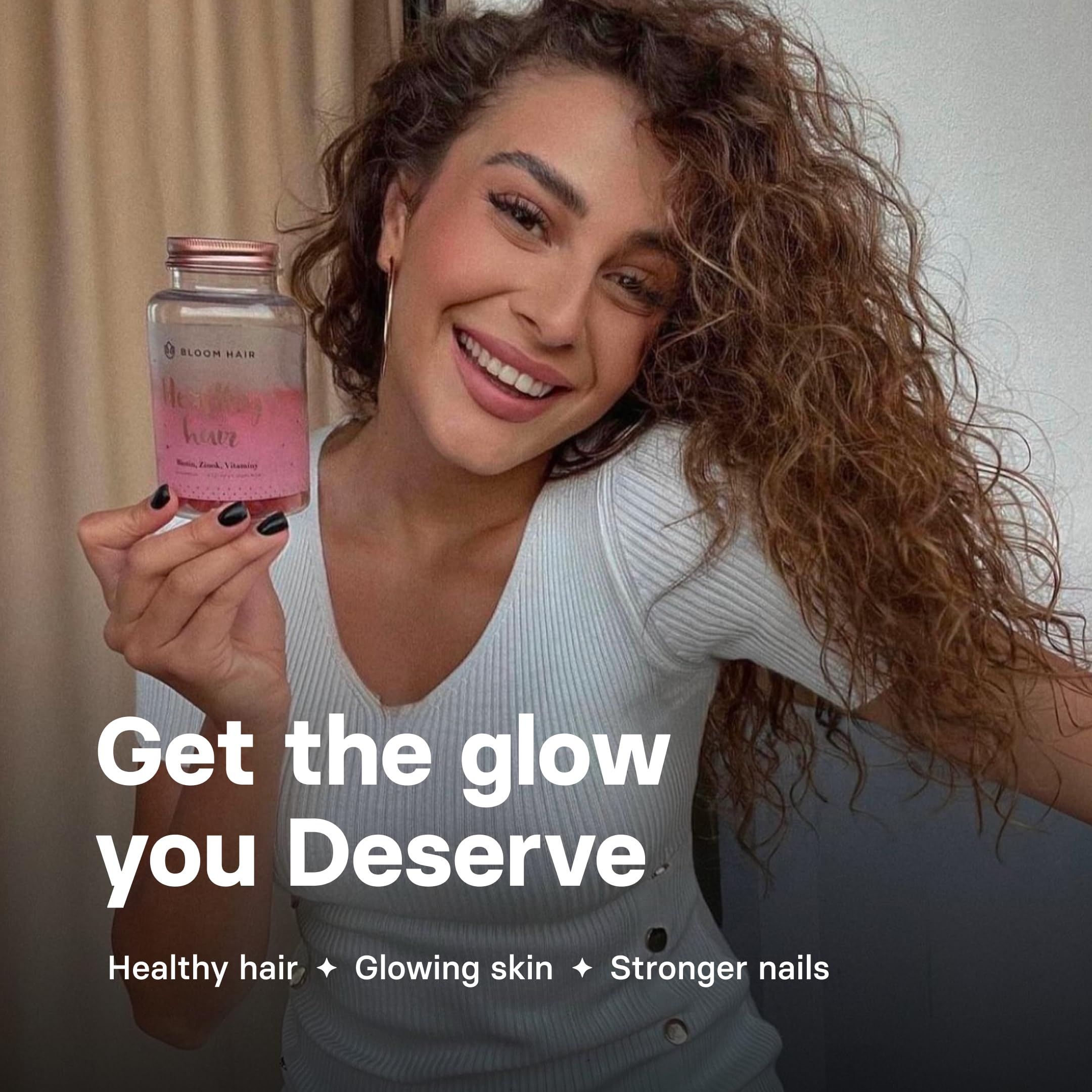 Lifestyle shot of a woman taking Bloom Hair Gummies
