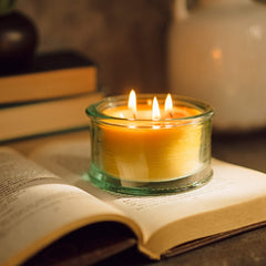Spruce scented beeswax candle in clear glass jar