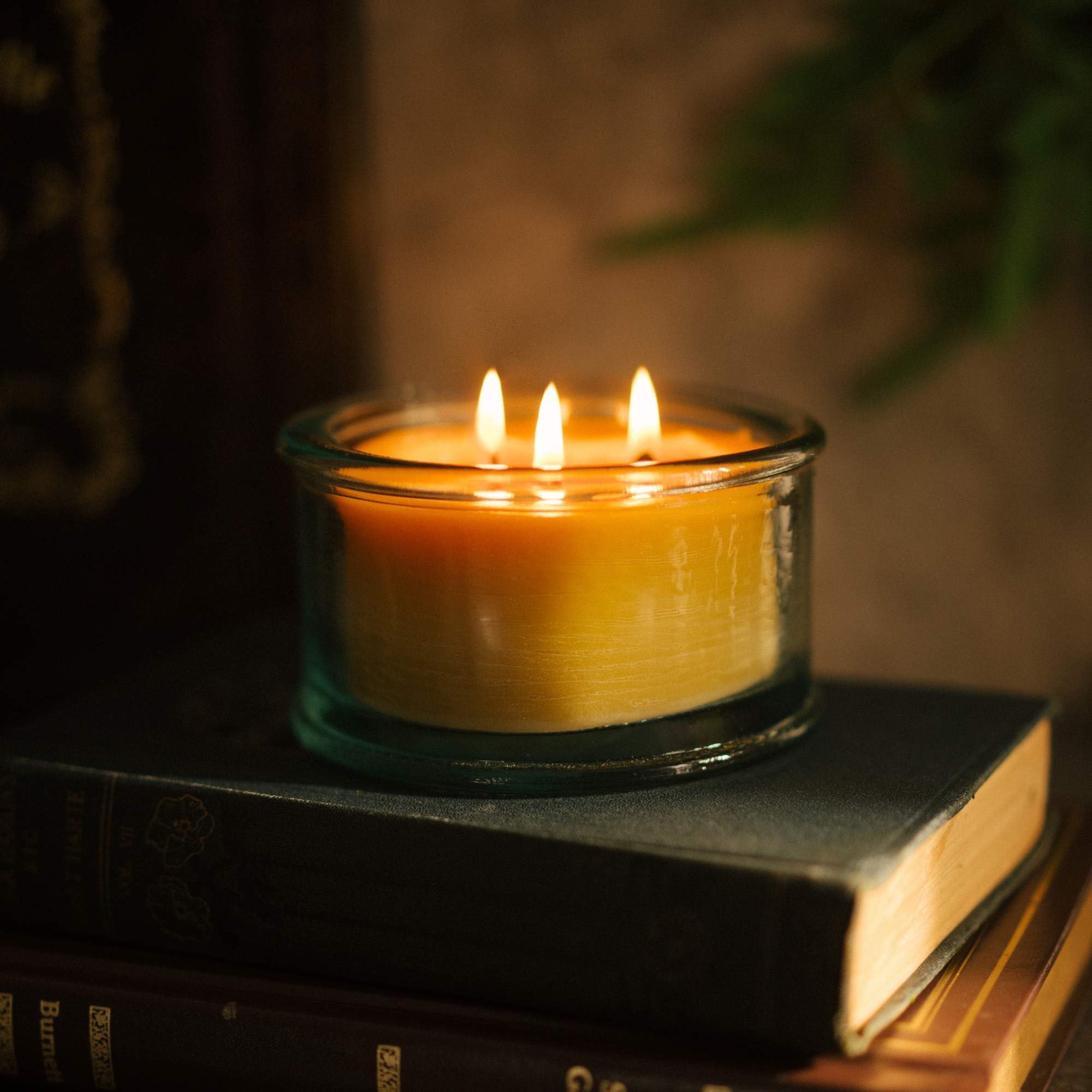 Warm glow from a 3-wick beeswax candle