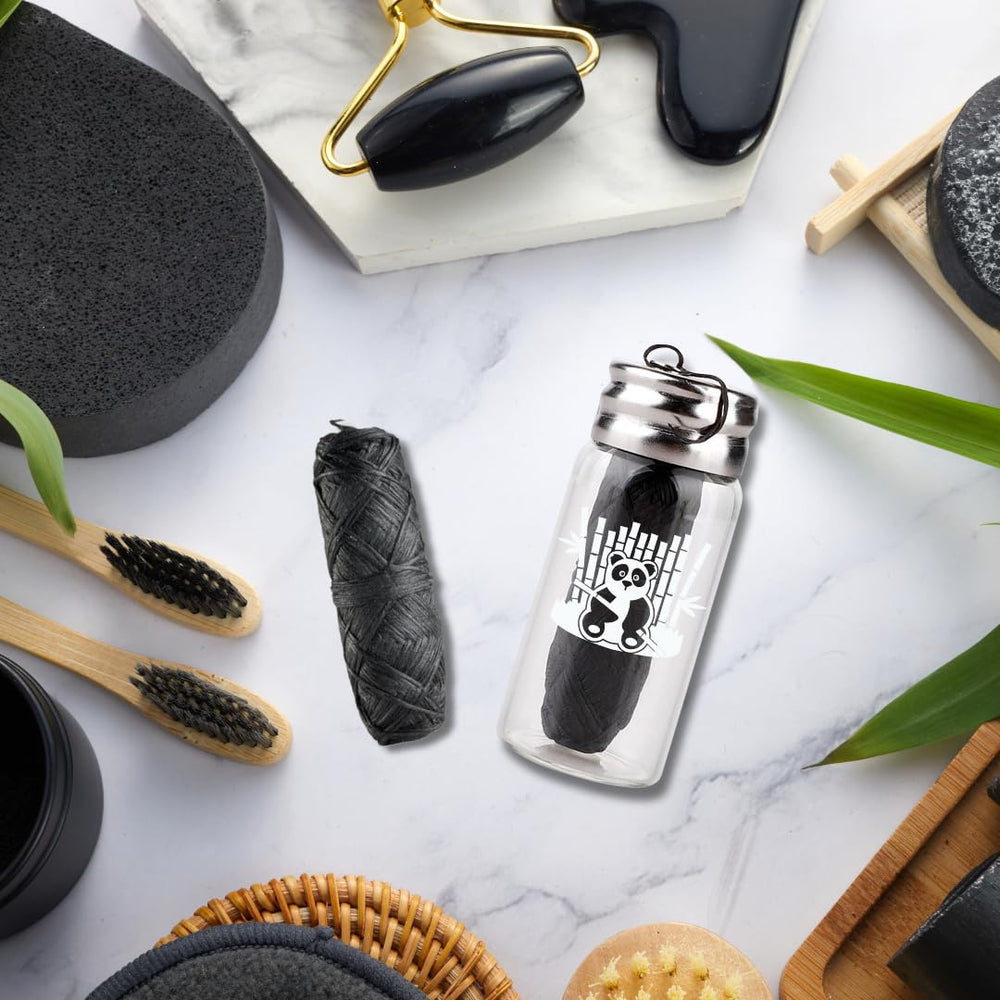Charcoal woven dental floss with glass bottle - side view