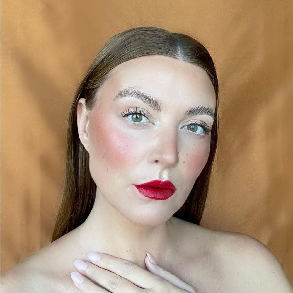 Bossy Cosmetics Ambitious Red lip closeup emphasizes vibrant pigment.