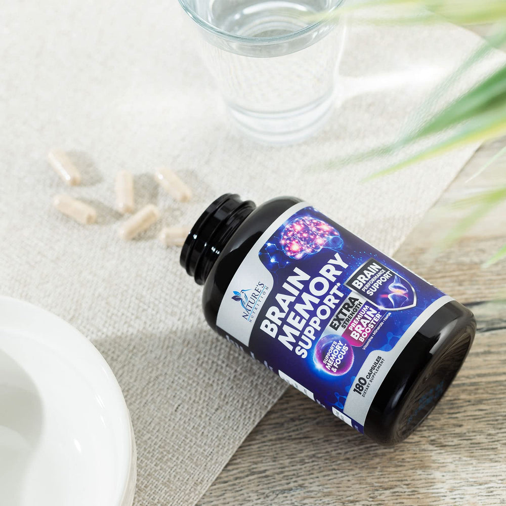 Adult at a desk focusing with Brain Memory Supplement bottle nearby