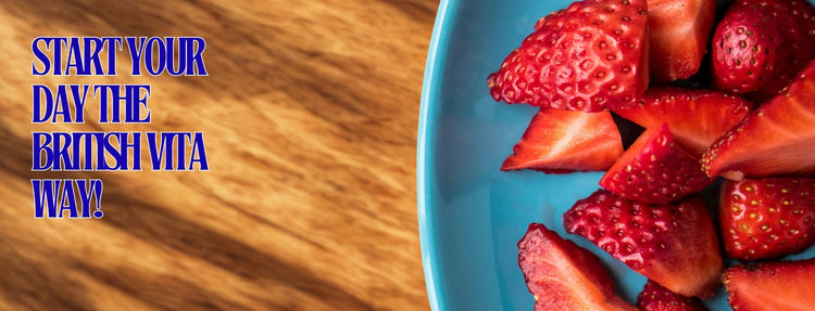 Blue plate with strawberries on a wooden surface, promoting 'The British Vita' brand.