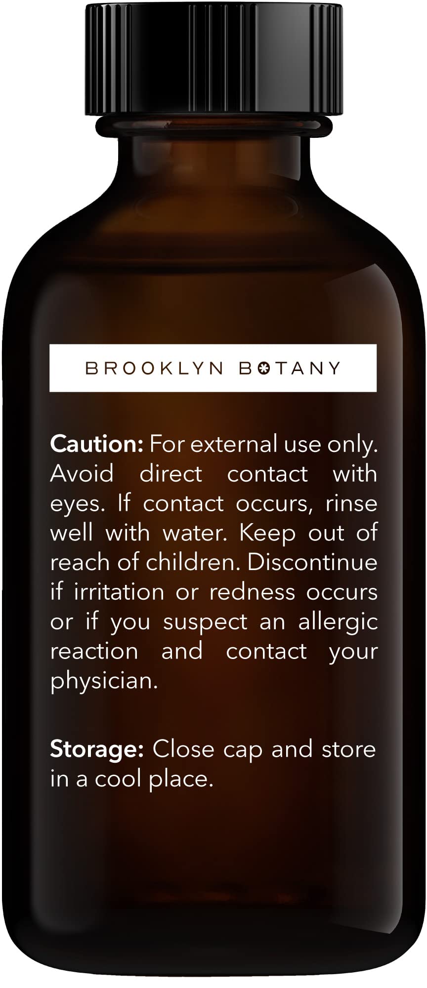 Dropper cap next to Basil Essential Oil bottle