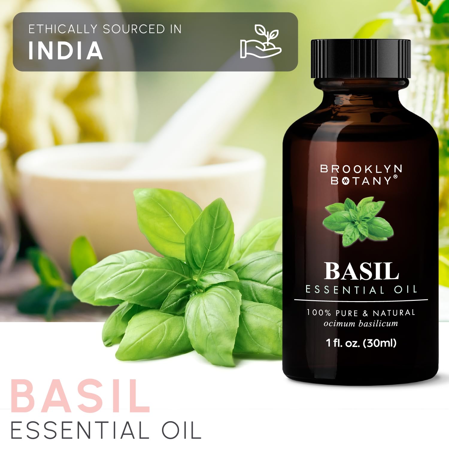 Open glass dropper releasing basil essential oil
