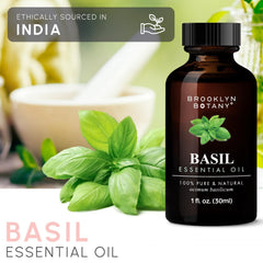 Open glass dropper releasing basil essential oil