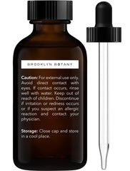 Close-up of rosemary essential oil in amber glass bottle