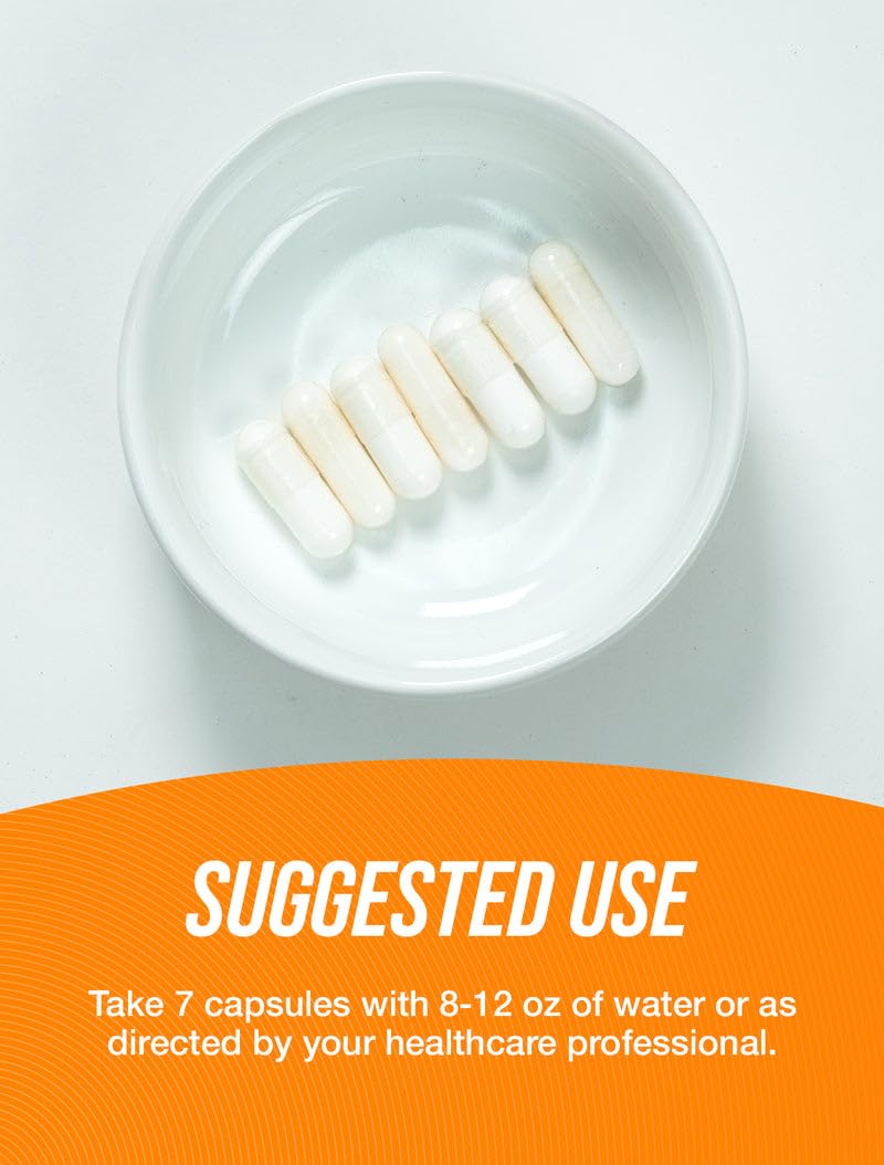 Creatine monohydrate capsules and bottle close-up