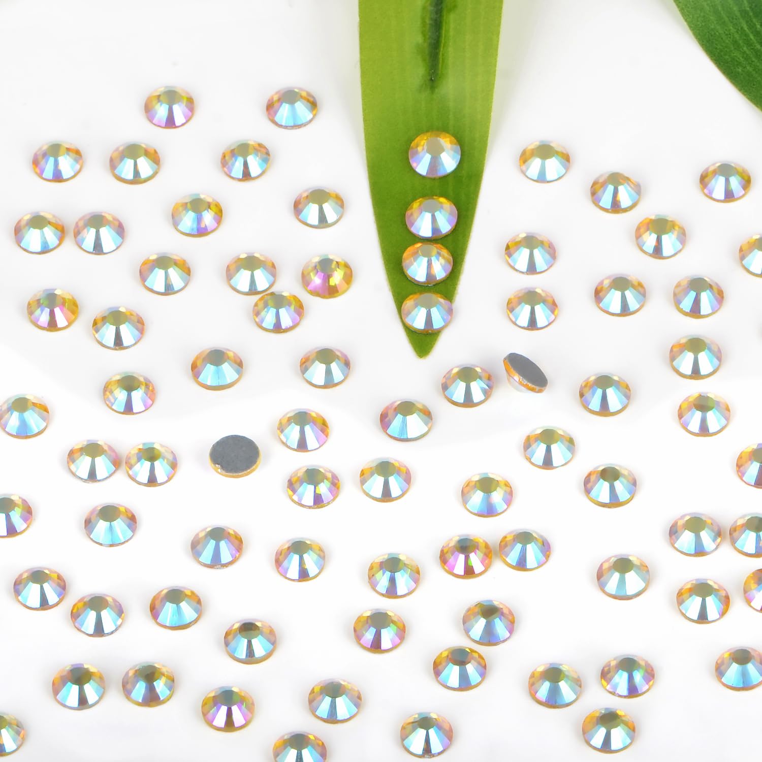 Close-up of Bymitel Citrine AB glass rhinestones ready for heat-activated adhesion.
