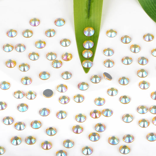 Close-up of Bymitel Citrine AB glass rhinestones ready for heat-activated adhesion.