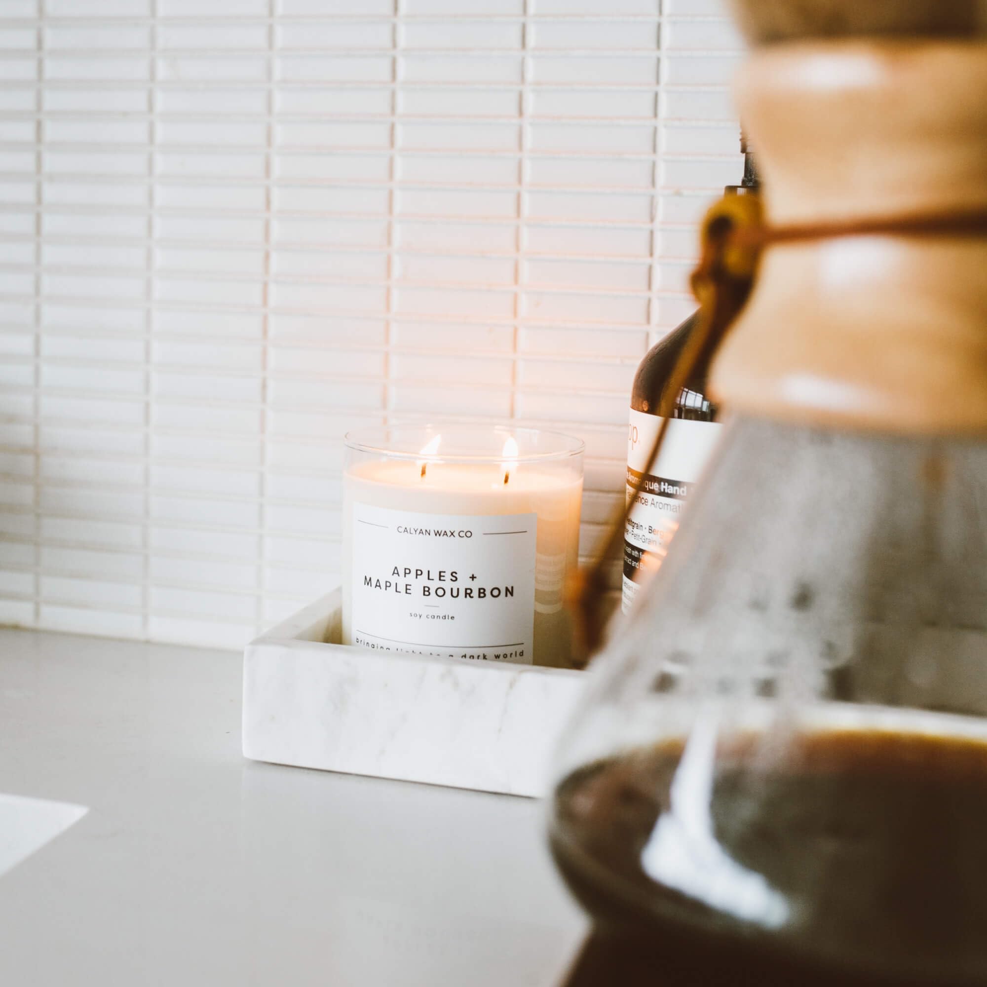 Lifestyle shot of the candle in a cozy living room setting