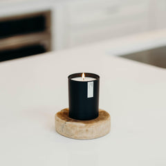 Ambient lit scene featuring the Aspen & Fog candle in a cozy room.