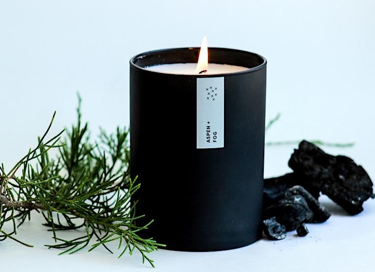 Packaging image showing the Aspen & Fog candle with its label beside the tumbler.