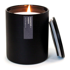 Calyan Oakmoss & Amber candle in a matte black tumbler jar