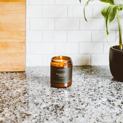 Close-up of amber glass jar and wick