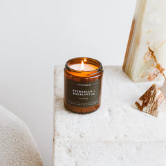 Lifestyle scene featuring Evergreen & Eucalyptus candle in a cozy space