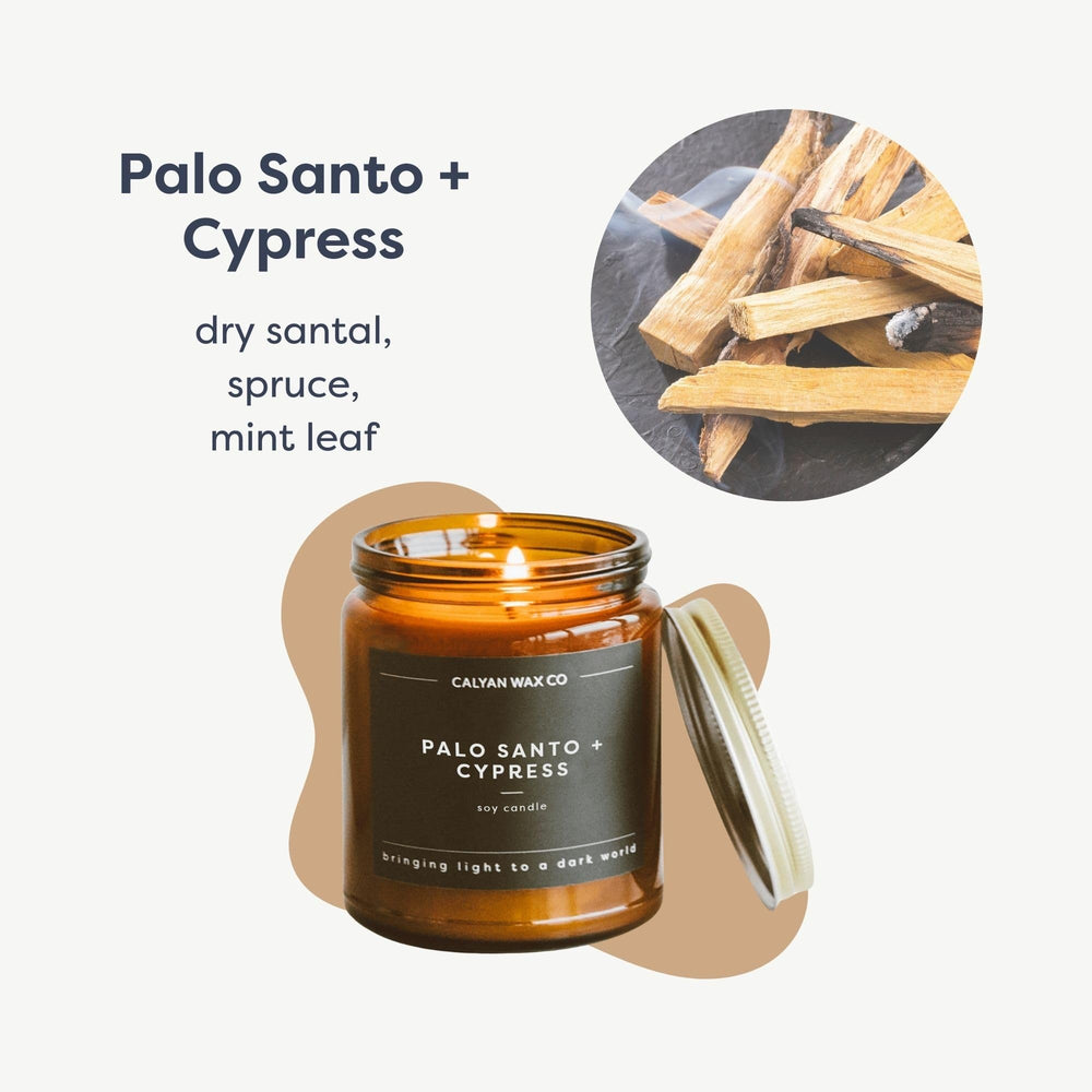 Amber glass jar candle with Palo Santo & Cypress label, angled side view