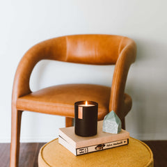 100% soy wax being hand-poured into the black tumbler jar