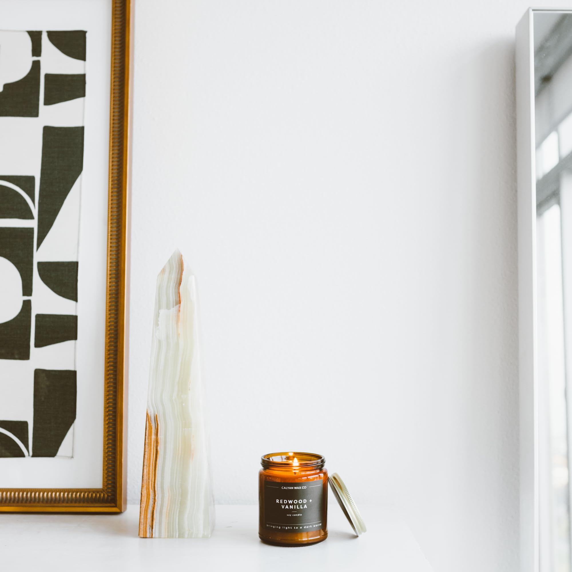 Lifestyle scene featuring Redwood & Vanilla candle in a cozy living space