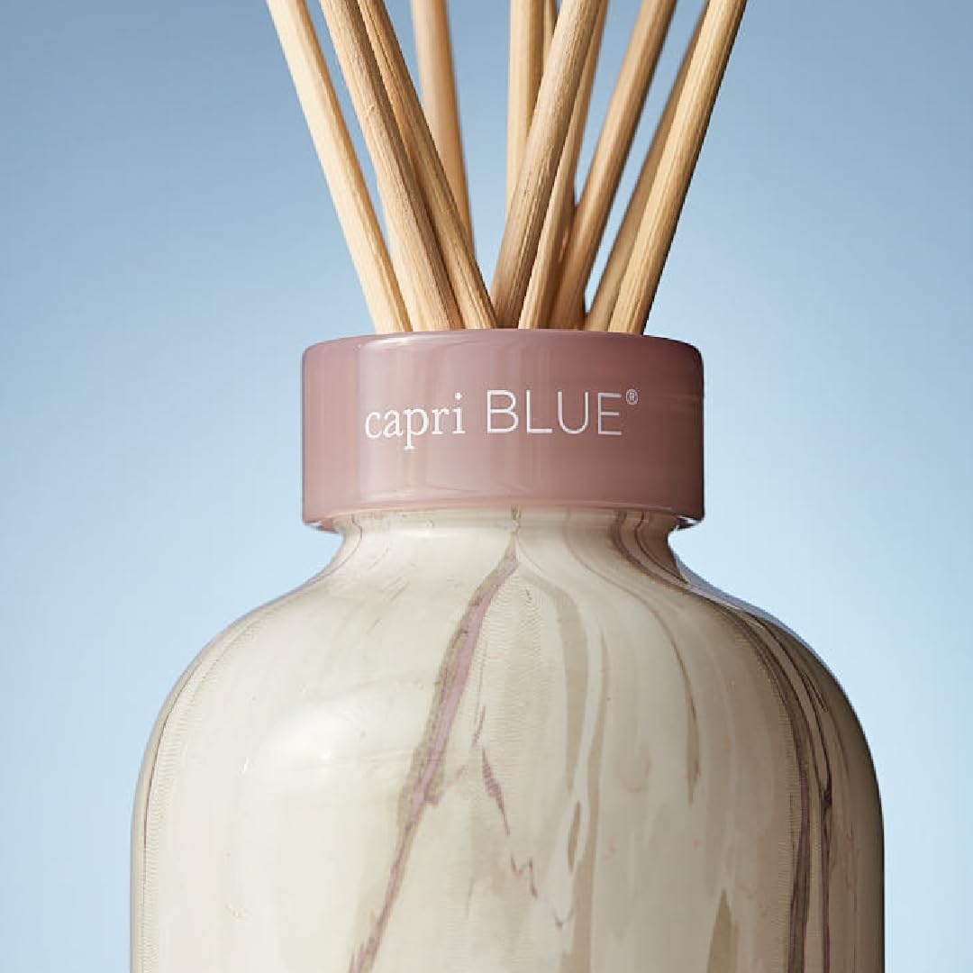 Reed sticks soaking in scented oil from Capri Blue diffuser