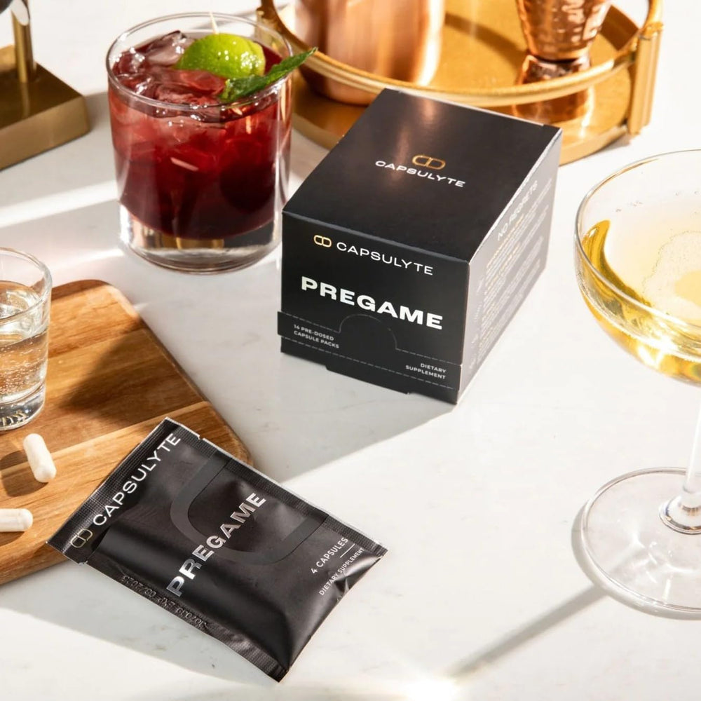 Capsulyte Pregame packets on desk beside a phone for party prep