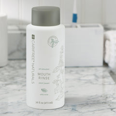 Dentist holding CariFree Naturals Mouth Rinse