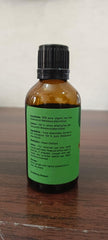 Fresh tea tree leaves and bottle on white background