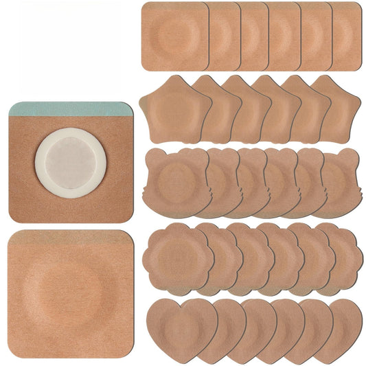Assorted shapes of disposable castor oil patches on a white surface
