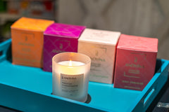 Candle burning with warm fragrance throw in a living room