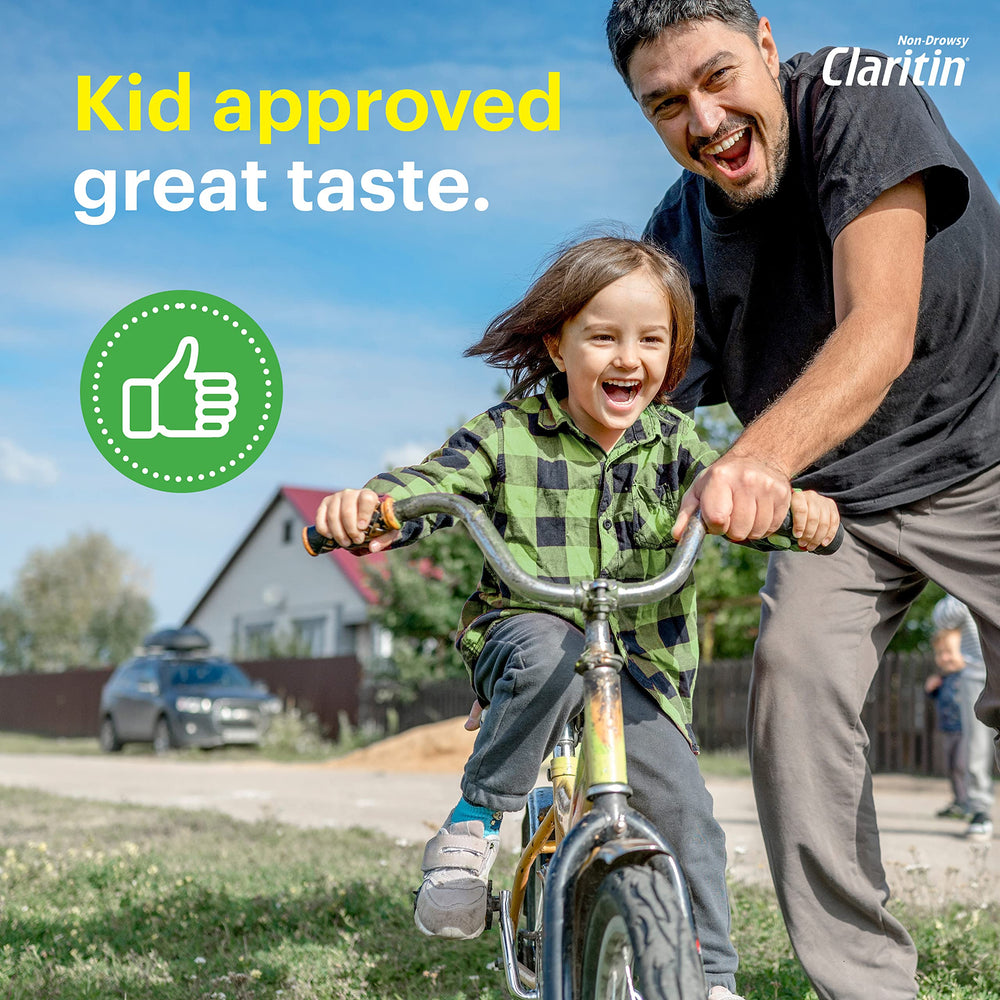 Claritin chewables grape kid-taking shot conveys simple administration during daily routines.
