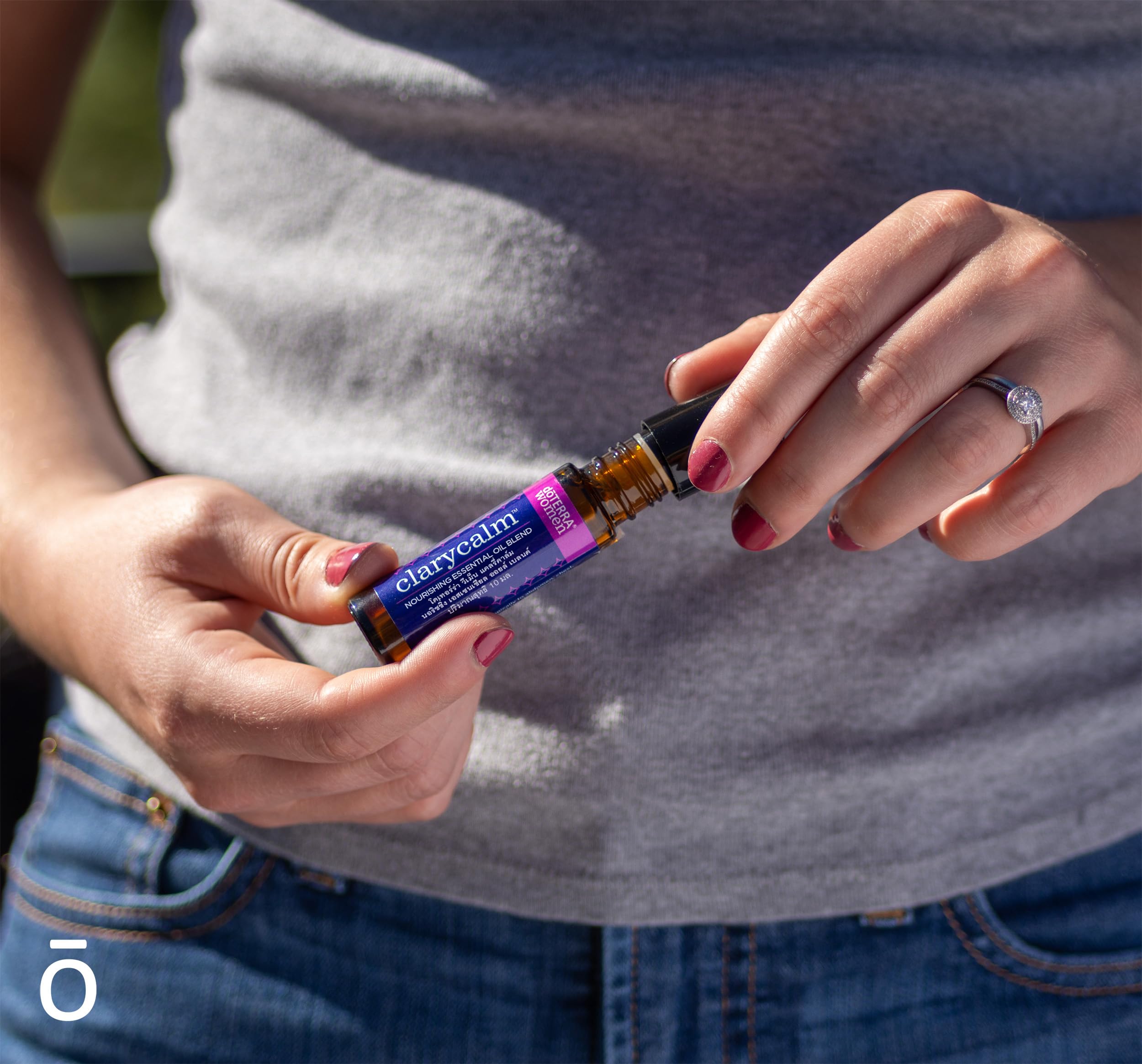 Assorted essential oils with Clary Calm bottle on wooden surface