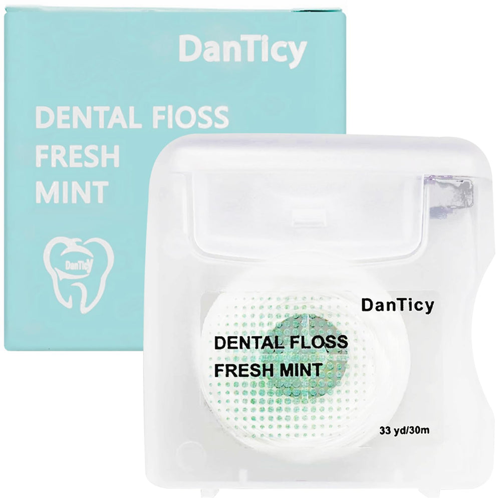 Close-up of mint coconut oil dental floss designed for wide spaces