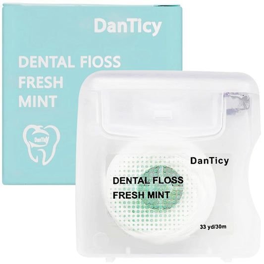 Close-up of mint coconut oil dental floss designed for wide spaces