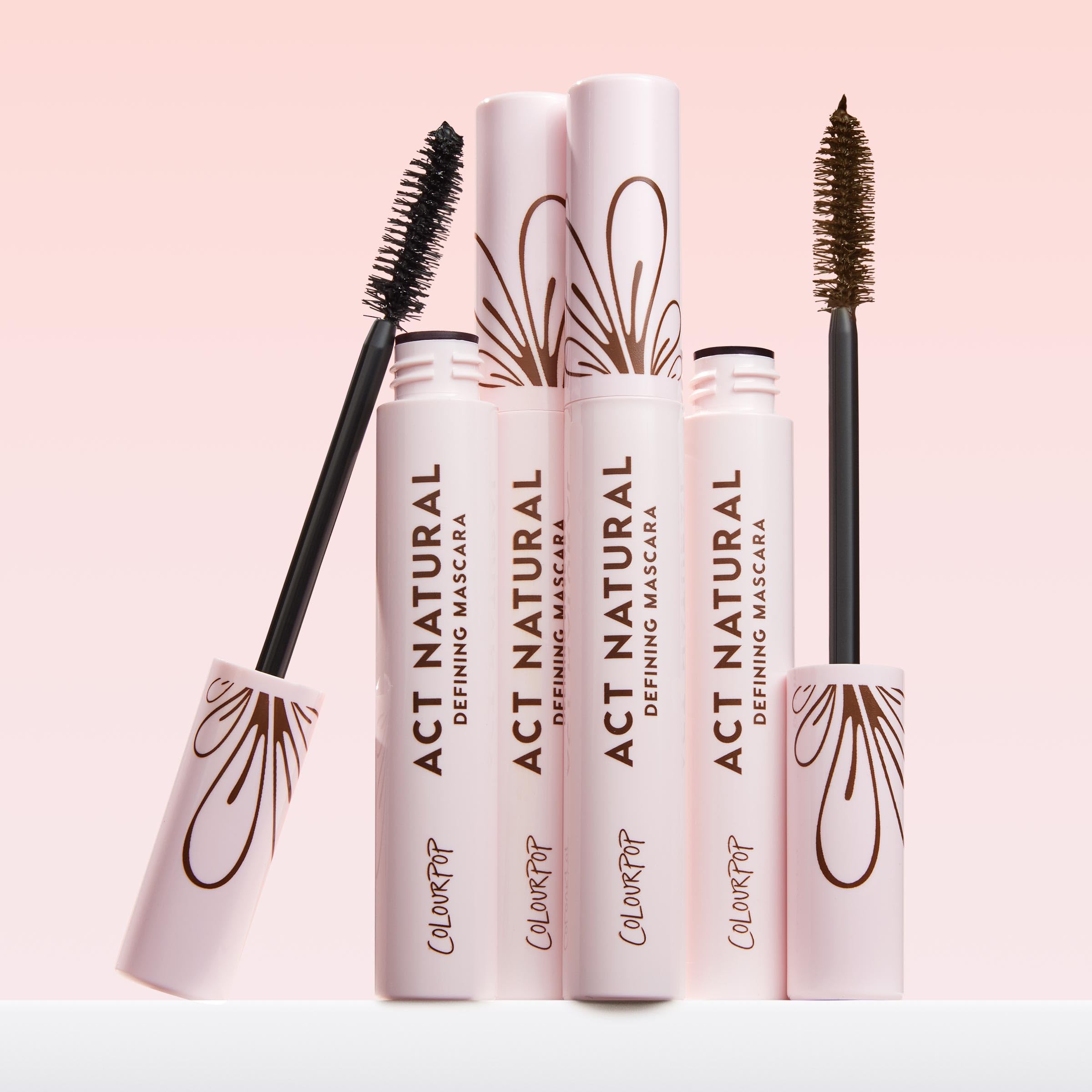 ColourPop Act Natural Defining Mascara tube beside neutral backdrop for everyday wear.