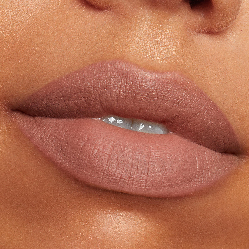 Close-up PowerPout Matte Lipstick velvet texture on lips.