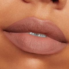 Close-up PowerPout Matte Lipstick velvet texture on lips.
