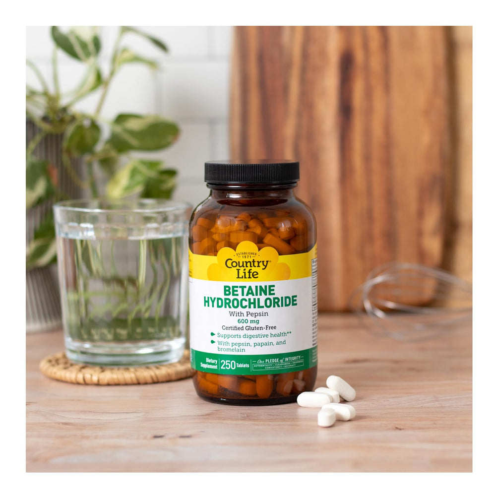 Bottled supplement with tablets on a white surface