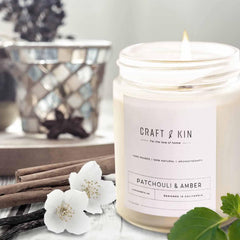 Cozy holiday scene featuring Patchouli & Amber candle