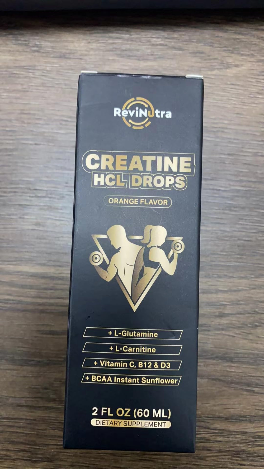 Close-up of orange-flavored Creatine HCl liquid drops
